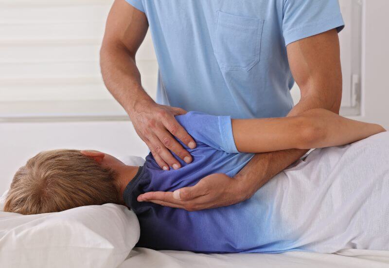 Boy having chiropractic back adjustment in Crofton, MD