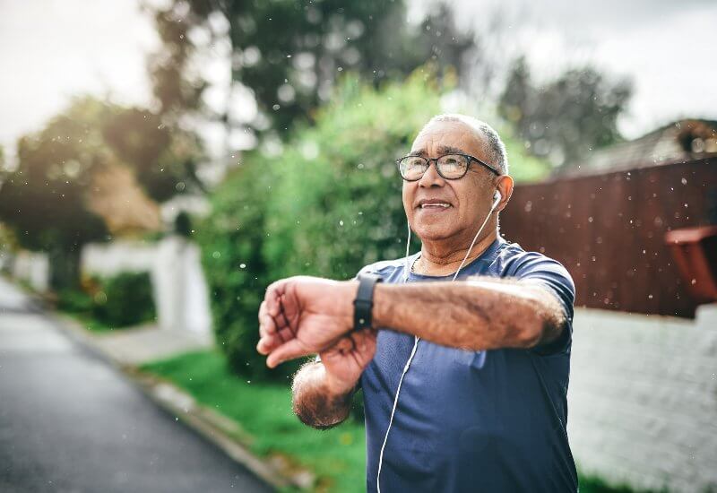 Man looking at watch after run