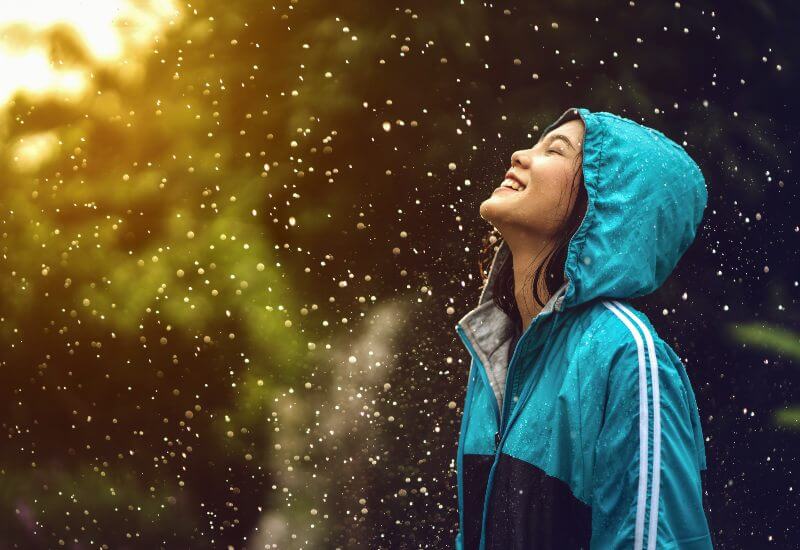 Woman with raincoat enjoying the rain outside in Maryland