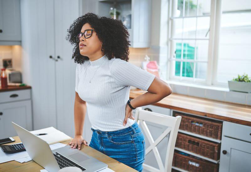 Young woman suffering from back pain