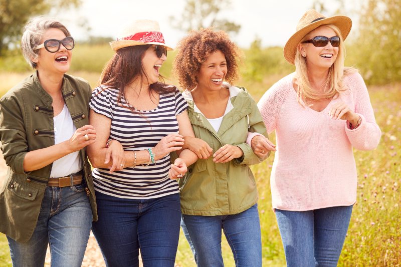 Group Of Mature Female Friends Walking Along Path at a Park
